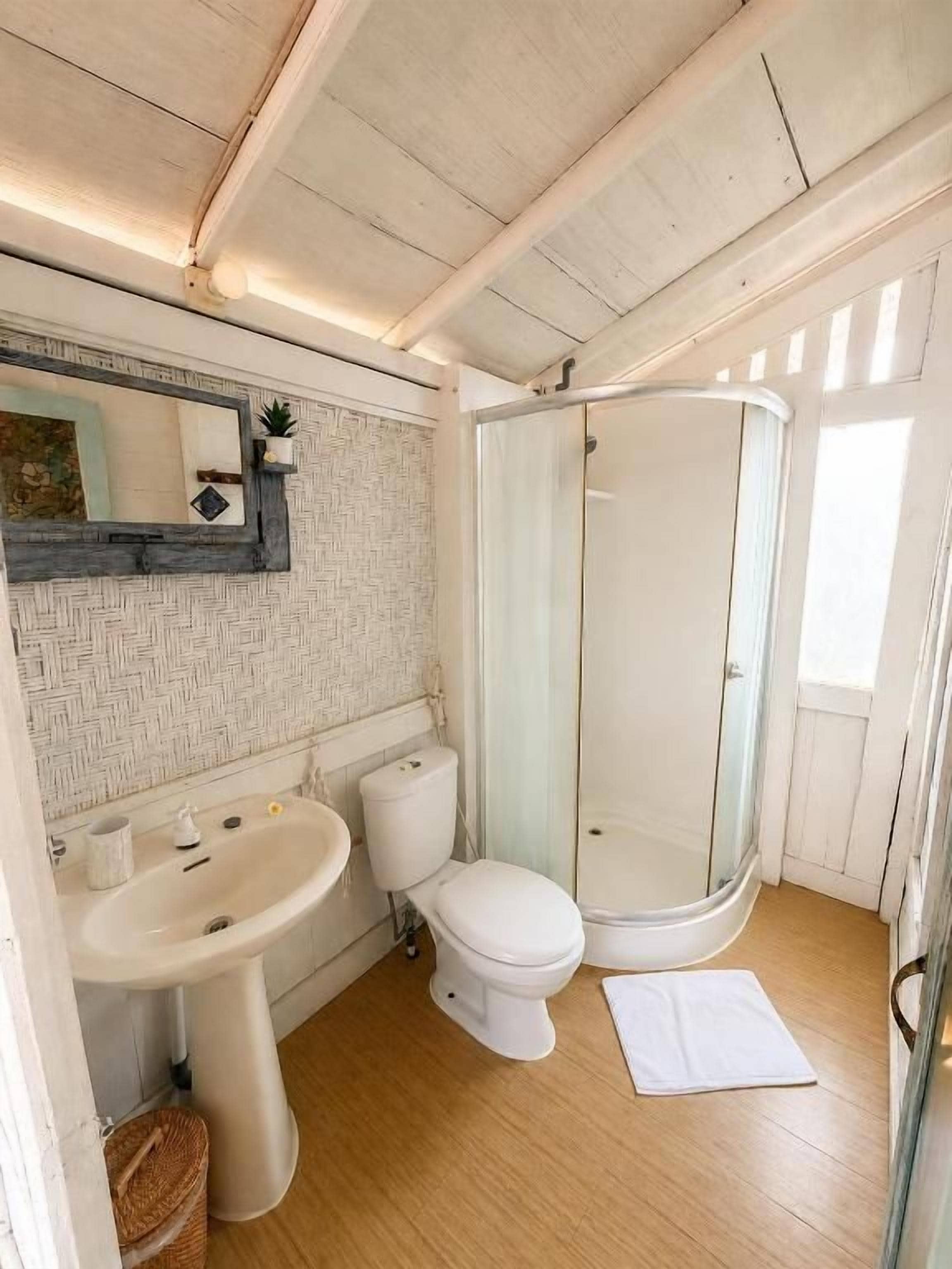 A bathroom with a sink, toilet, and shower.