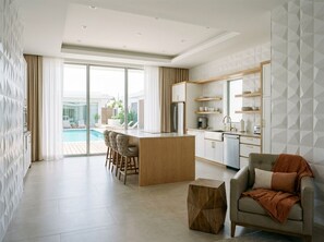 A modern living room with a sofa, a coffee table, and a dining area with chairs. - Spacious 4-bedroom house in tranquil Minneapolis with AC and gym (Minneapolis)