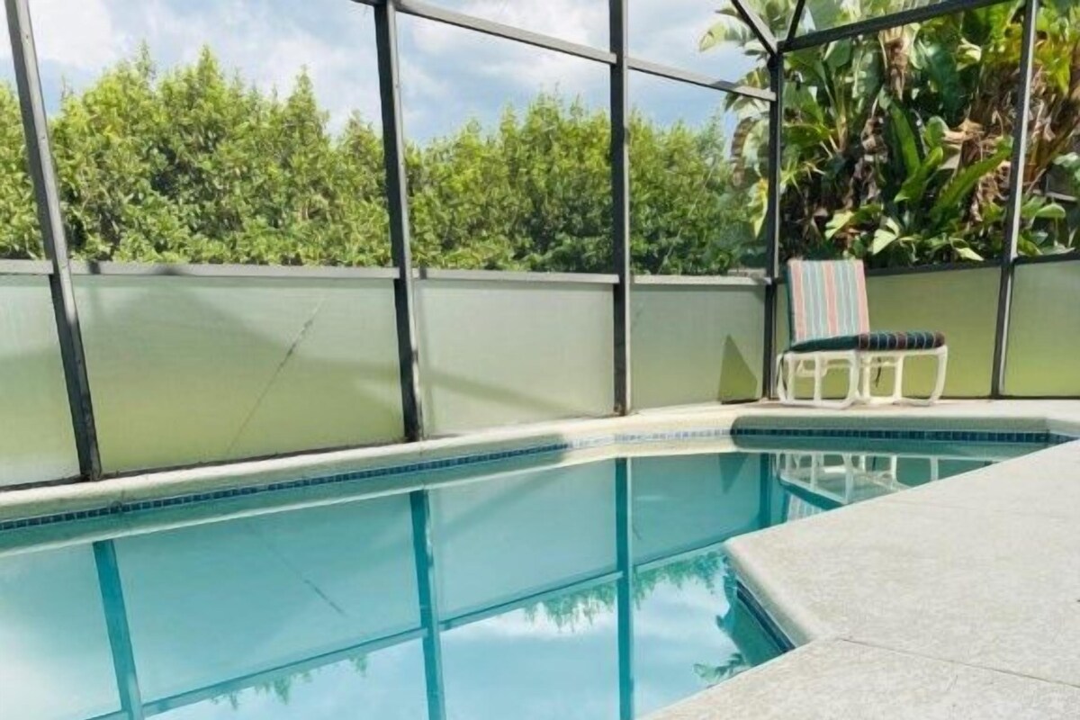 A poolside area with a welcome mat and a lounge chair.
