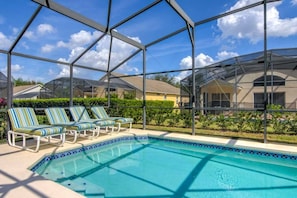 A swimming pool with lounge chairs and a greenhouse structure. - South Facing Pool & Game Room! 6 Bedroom Home (Haines City)
