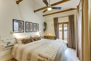 A bedroom with a bed, a ceiling fan, and a window with curtains. - Walk to RiNo & Coors Field! Modern Denver Home (Denver)