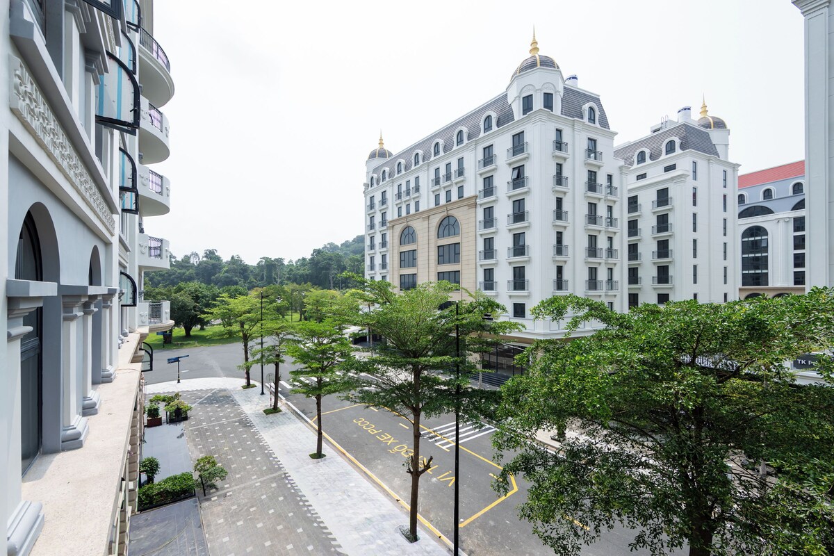 A multi-story hotel with a classic architectural design, featuring balconies and a central courtyard.