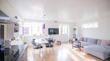 A modern living space with a kitchen, dining area, and seating area.