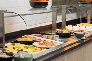 A buffet with various food items including meats, cheeses, and fruits. - Holiday Inn Express and Suites Sion By IHG (Sion)