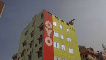 A multi-story building with a prominent vertical sign reading 'OYO' on the side.