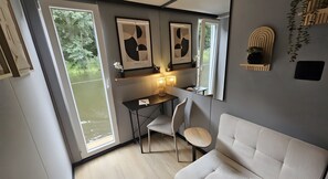A modern interior with a desk, chair, and sofa.