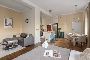 A modern apartment with a living area, kitchen, dining space, and a small island with stools. - Lumina 2room Apt w/ Parking near center (Warszawa)
