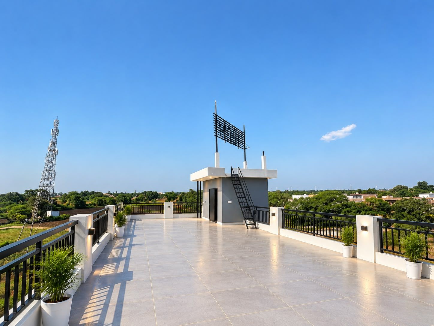 Una terraza en la azotea con una bandera, una estructura metálica y vistas del entorno.