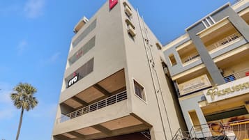 A multi-story building with a prominent 'OYO' sign on the facade, indicating a hotel or hostel.