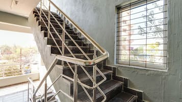 A staircase with metal railings and a window with metal bars.