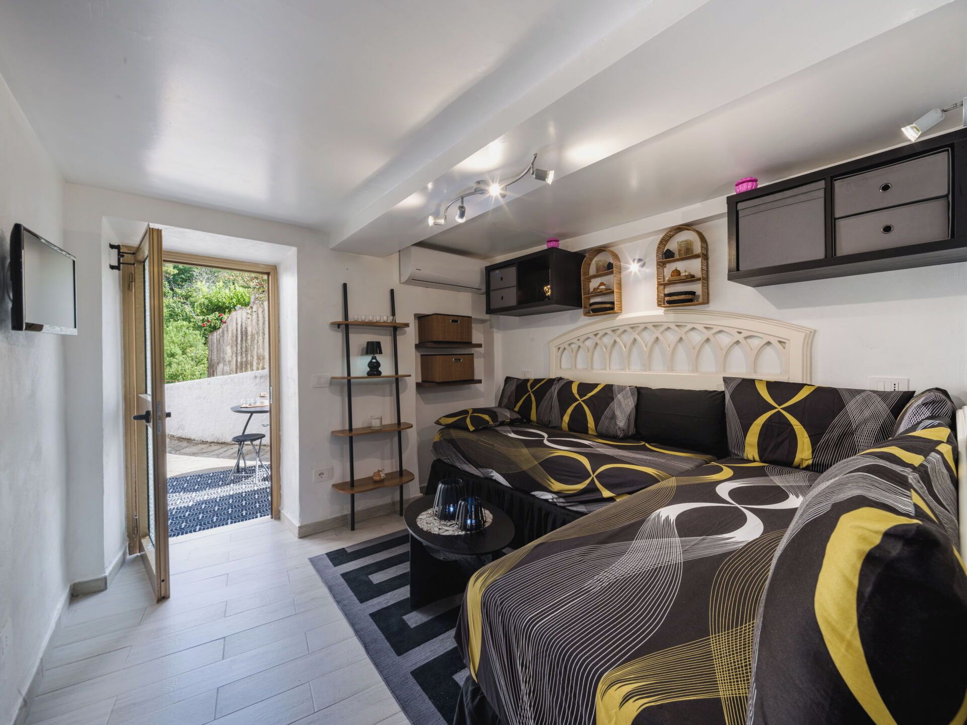 A bedroom with a bed, bedside tables, a wardrobe, and a window.