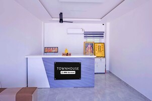 A reception desk with a sign indicating it is serviced by OYO.