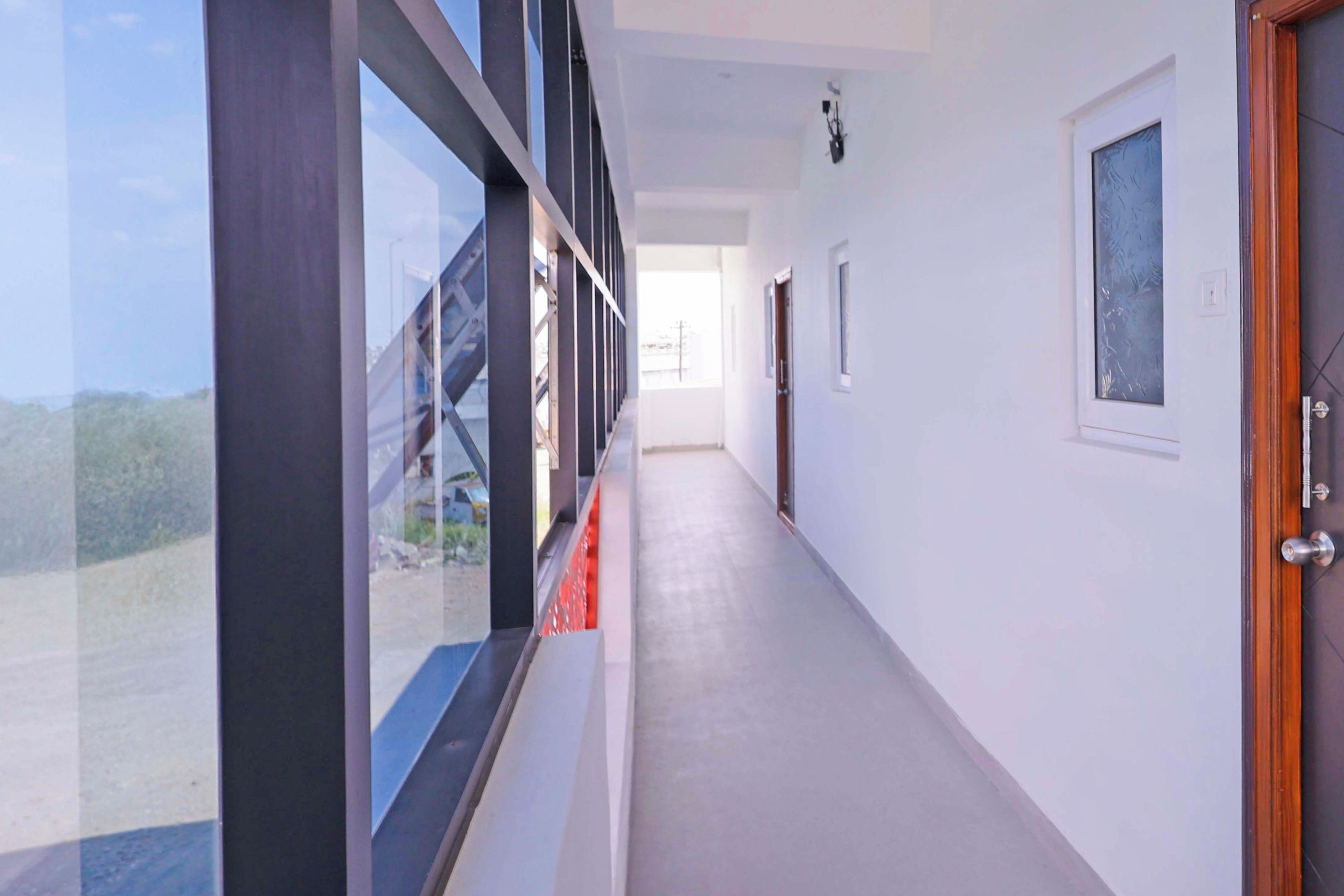 A corridor with a view of a bridge and a door on the right.