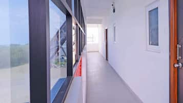 A corridor with a view of a bridge and a door on the right.