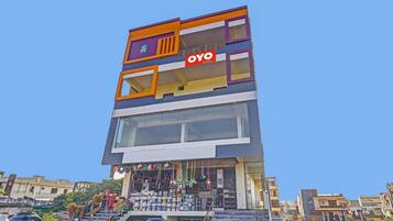 A multi-story building with a prominent 'OYO Rooms' sign.