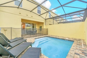 An indoor swimming pool with a glass ceiling, surrounded by lounge chairs. - Solara Resort - 34550 (Kissimmee)