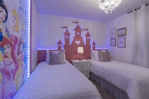 A bedroom with two beds, a nightstand, a wall mural, and a chandelier. - Windsor Island - 7856 (Davenport)
