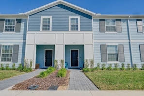 A two-story residential building with a symmetrical facade, numbered 3129 and 3125, featuring a central entrance with double doors and a small porch area. - Windsor Island - 11653 (Davenport)