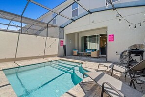 An outdoor swimming pool with lounge chairs and a covered seating area. - Solara Resort - 29105 (Kissimmee)