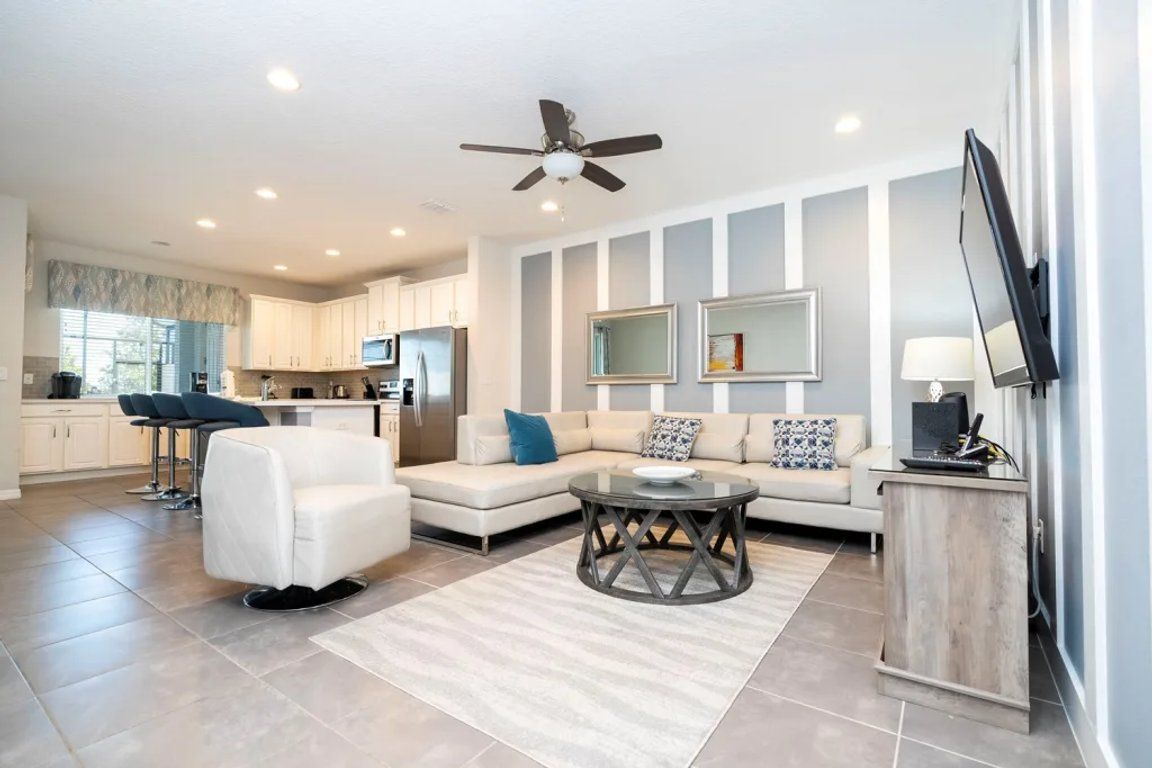 A modern living room with a sofa, coffee table, and a television.