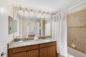 A bathroom with two sinks, a large mirror, and a shower curtain. - Paradise Palms - 6135 (Kissimmee)