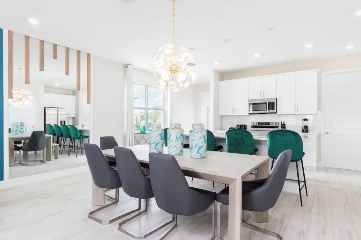A modern kitchen with white cabinets, a microwave, and a stove.