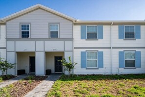 A two-story residential building with a symmetrical facade, numbered units 4294 and 4298, and a small front yard with a pathway. - Windsor Island - 7711 (Davenport)