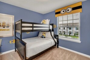 A bunk bed room with a window and a framed picture on the wall. - Windsor at Westside - 26139 (Kissimmee)