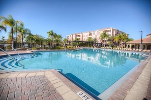 A swimming pool with a 3 ft depth marker, surrounded by palm trees and a building with balconies. - Vista Cay - 27376 (Orlando)