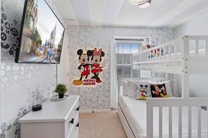 A child's room with Mickey and Minnie themed decorations, bunk beds, and a desk. - Windsor Island - 29337 (Davenport)