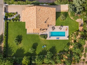 A rooftop pool area with a wooden deck, lounge chairs, and a swimming pool. - Vrbo Property (Pyla-sur-Mer)