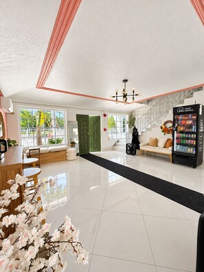 A hotel lobby with a seating area, a vending machine, and a staircase. - #12 – Modern Studio in Miami Mimo / Free Parking / Kitchen (Miami)
