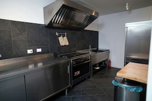 A modern kitchen with a stainless steel range, oven, and a built-in microwave. - Villa with private pool, gym, games close to lake (Bracciano)