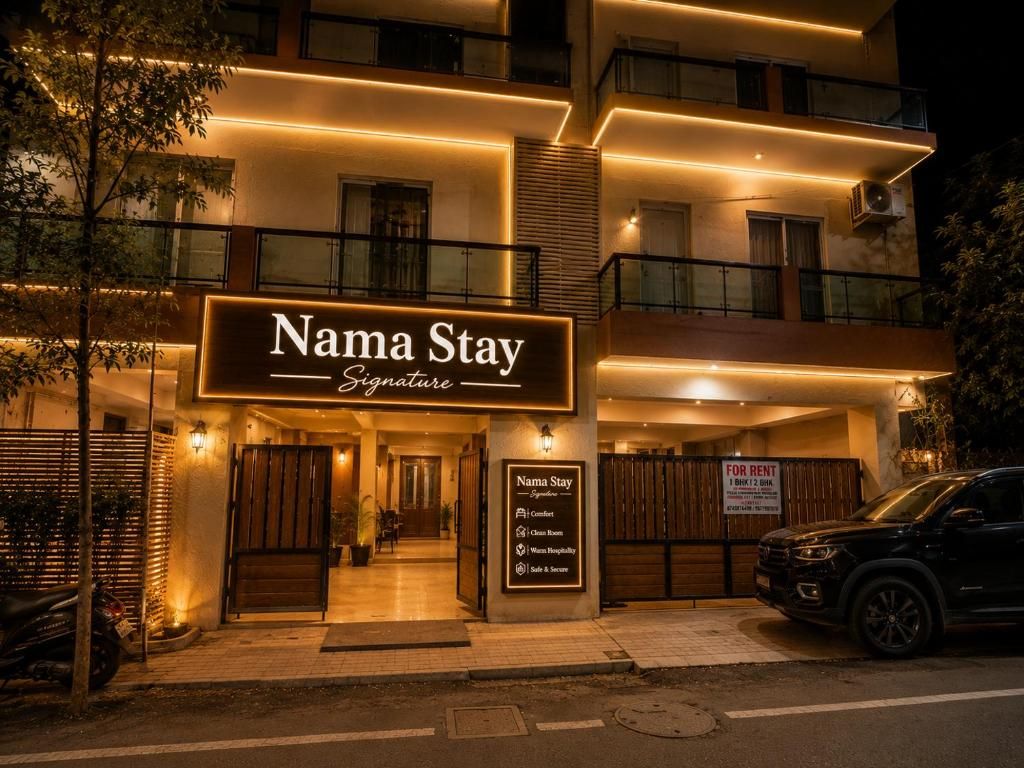 A multi-story building with a sign reading 'Nama Stay Signature.'