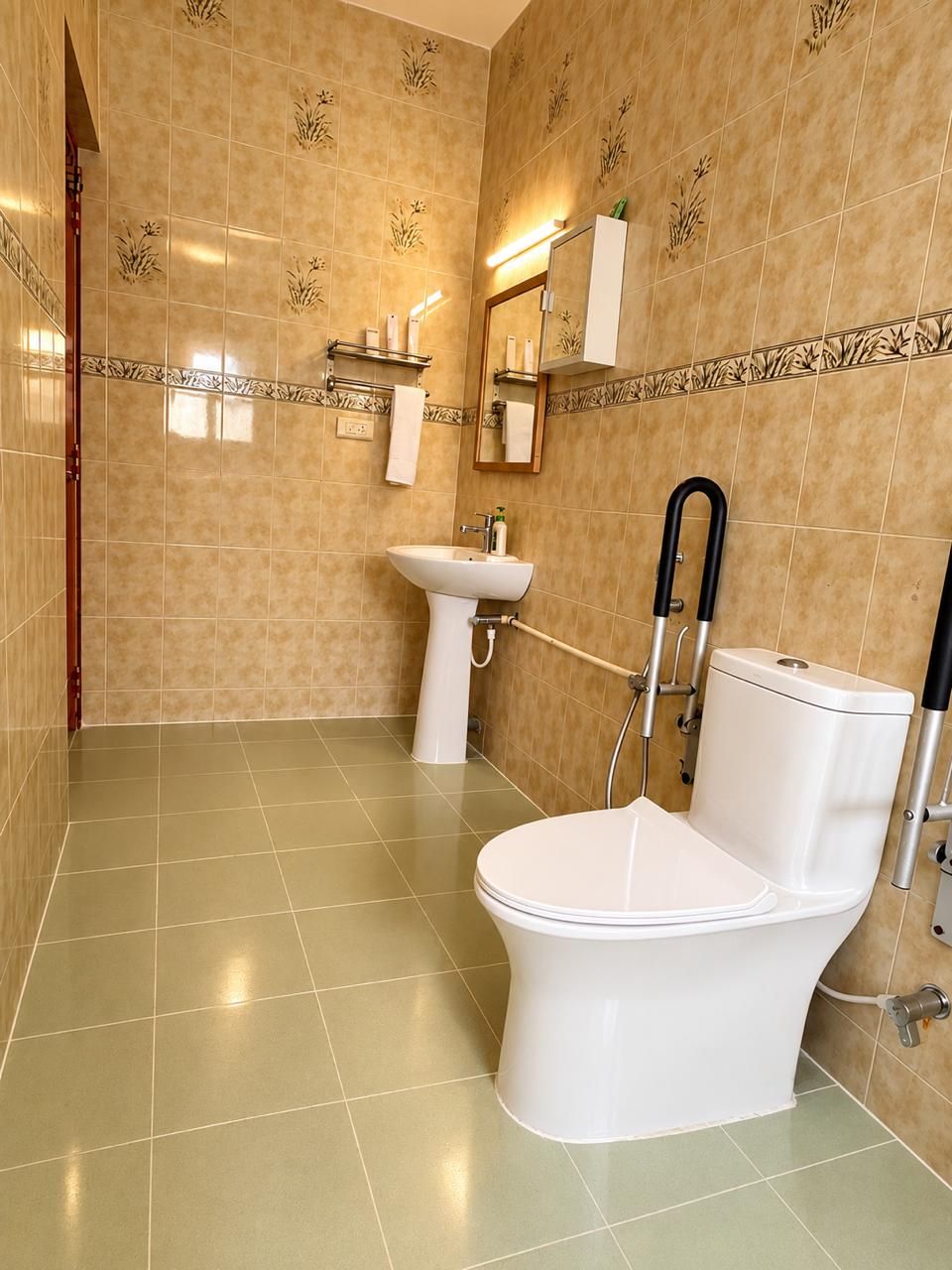 Baño con inodoro, lavamanos y zona de ducha.