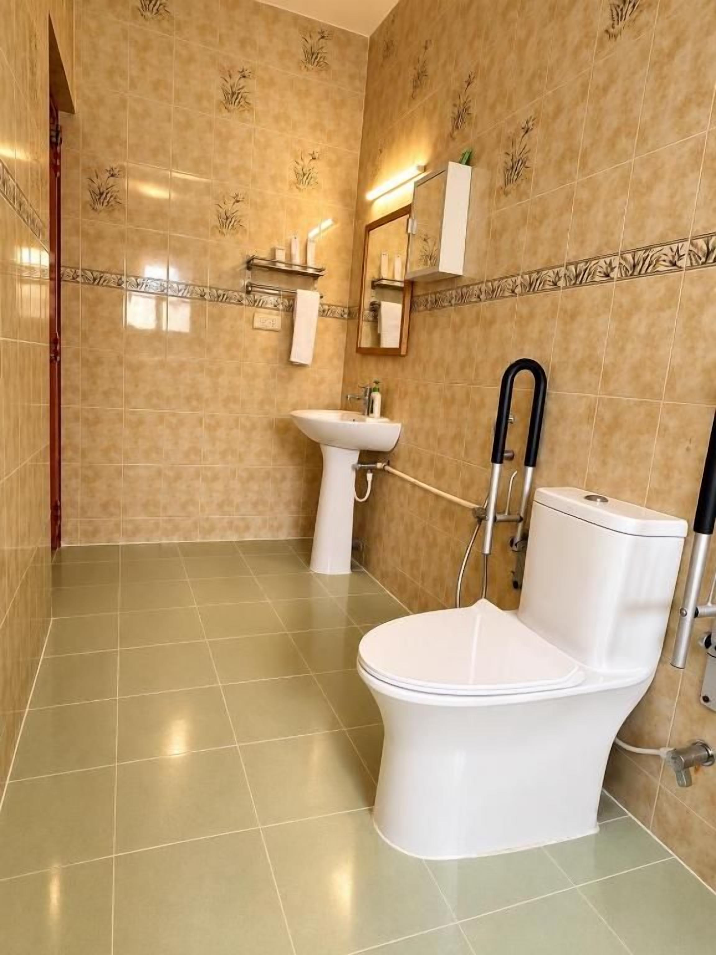 A bathroom with a toilet, sink, and shower.