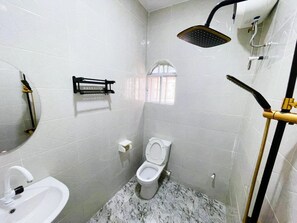 A small bathroom with a toilet, sink, and shower. - MAGS RESIDENCE (Asubi)