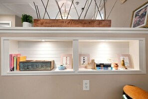 A bookshelf with books and decorative items. - NEW! Row & Behold - We love Dogs! (Wilmington)