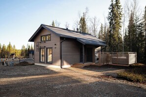 A modern house with a sloped roof, a front porch, and a gravel driveway. - Alpine South Slope A7 by Aavalevi (Levi)