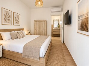 A bedroom with a bed, bedside table, lamp, wall art, wardrobe, and a TV. - Villa Green Paradise Private Pool & Garden Retreat (Lequile)