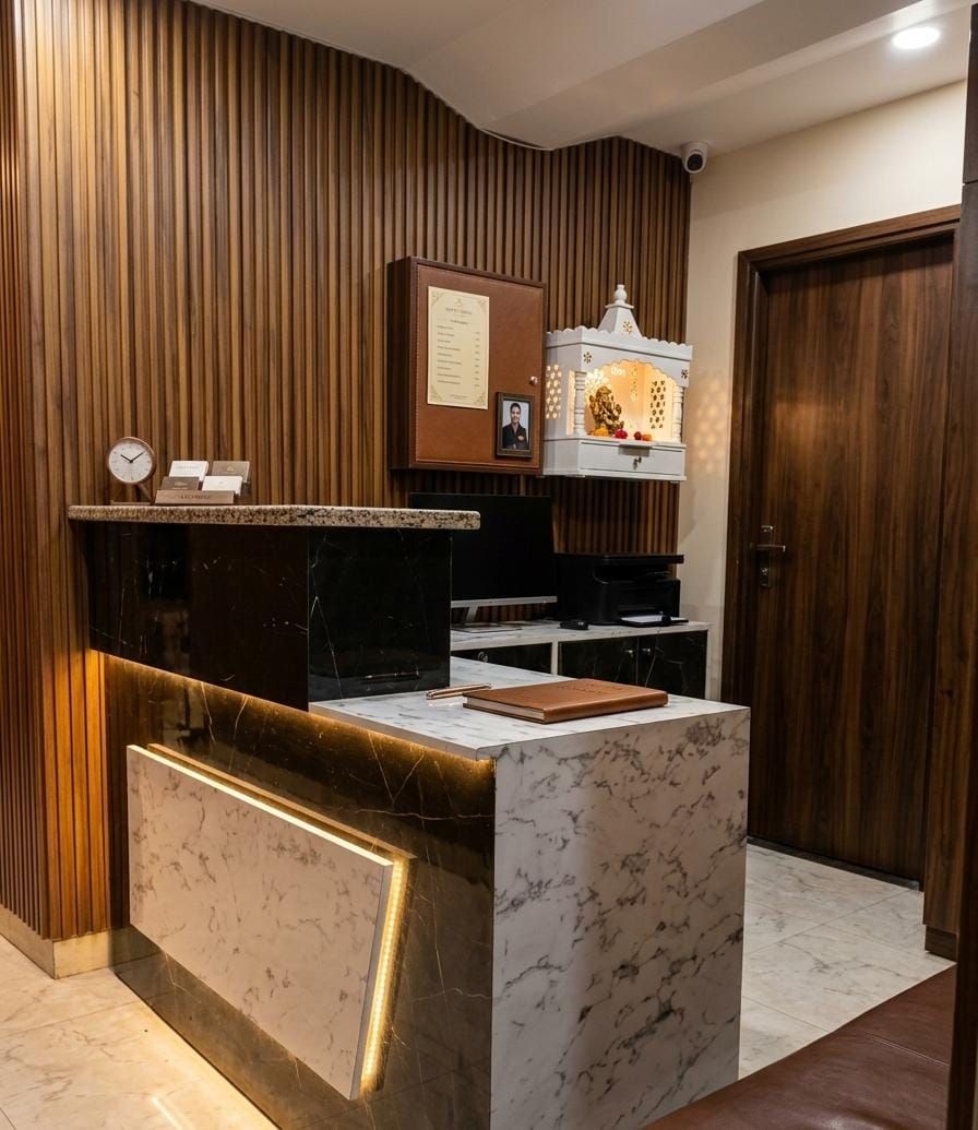 A reception desk with a marble top, a clock, and a framed certificate on the wall.