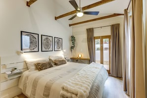 A bedroom with a bed, a ceiling fan, and a window with curtains. - Walk to Rino & Coors Field! Modern Denver Home (Denver)