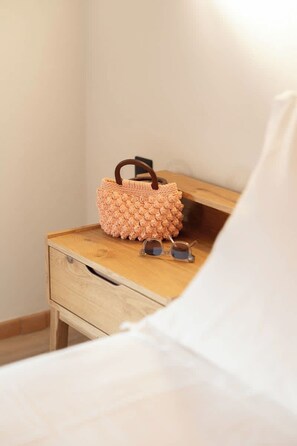 A wooden bedside table with a woven bag and a pair of sunglasses on it. - Liokrina Suite 06 - Livadakia Poolside Getaway! (Livadakia)