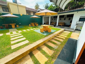 A courtyard with outdoor seating, a central table, and a patterned walkway. - Calm & Convenient Villa in the Heart of Galle City,Minutes away from Galle Fort (Galle)