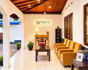 A hotel lobby with a reception desk, seating area, and a sign reading 'Villa 73'. - Calm & Convenient Villa in the Heart of Galle City,Minutes away from Galle Fort (Galle)