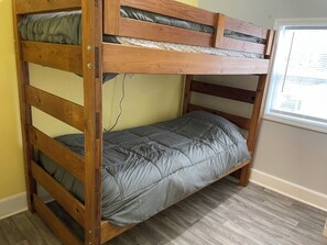 A bunk bed with a mattress and a wooden frame. - Spacious 7-bedroom house in serene Fort Wayne with AC. Big Groups only (Fort Wayne)