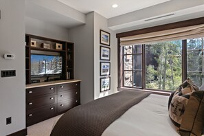 A bedroom with a large window, a bed, a dresser, and a television. - Flagstaff Lodge at Deer Valley Resort - Three Bedroom Residence #304 3 Condo (Park City)