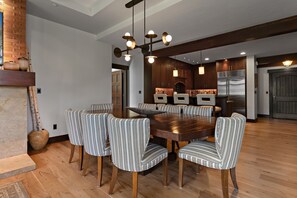 A modern kitchen with a large island, wooden cabinets, and a stainless steel refrigerator. - Flagstaff Lodge at Deer Valley Resort - Three Bedroom Residence #304 3 Condo (Park City)