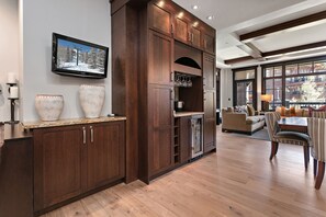 A modern kitchen with dark wood cabinetry, a built-in refrigerator, and a large window overlooking a snowy landscape. - Flagstaff Lodge at Deer Valley Resort - Three Bedroom Residence #304 3 Condo (Park City)