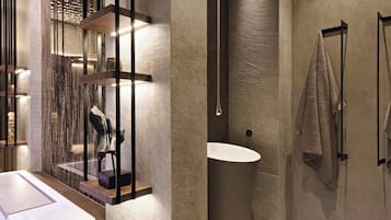 Un baño moderno con una bañera grande, zona de ducha separada y diseño minimalista.
